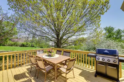 a wooden deck with a table and a stove at Williamstown Vacation Rental Private Deck and Yard in Williamstown