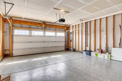 a garage with white garage doors in a room at Spacious Home with Patio Near Fishers! in Fishers