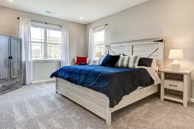 a bedroom with a large bed and a window at Spacious Home with Patio Near Fishers! in Fishers