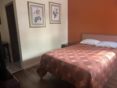 a bedroom with a bed and two pictures on the wall at Express Motel in Northwood