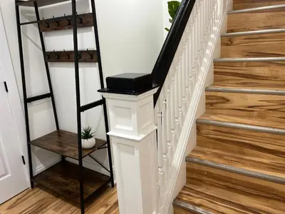 a staircase with a white rail and a black shelf at Trendy in Tremont, Cleveland (Upper) in Cleveland